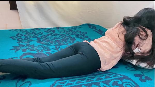 18 year old Girl lie on the bed playing games w...